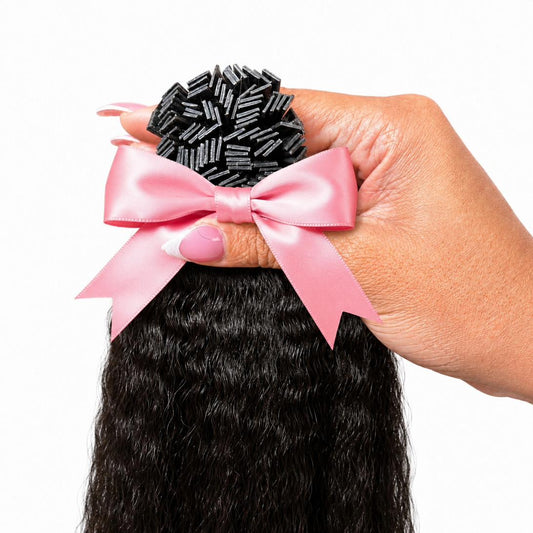 1B Yaki Straight K-Tip extensions 100g pack held in hand with pink satin bow — Straight Collection by TT Does It All